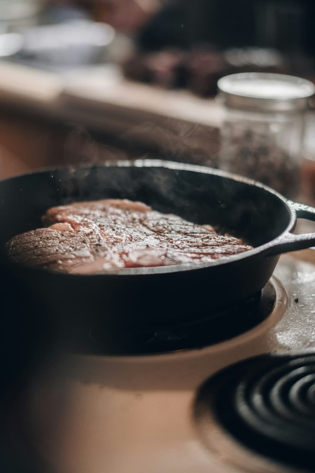 Steak searing in a cast-iron pan